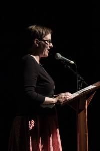 A woman reading at a lecture